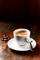 Cup of coffee on wooden background.