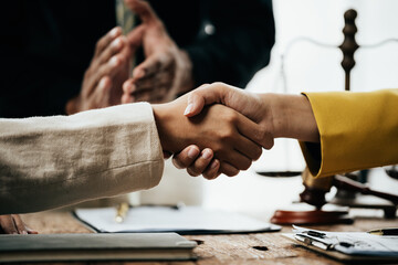 Close up of hands Lawyers explain and discuss matters of law then shakehands after and dealing...