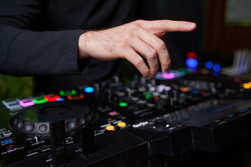 Fototapeta premium control DJ for mixing music with blurred people dancing at party in nightclub.