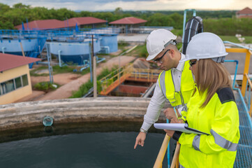 Fototapeta premium Environmental engineers work at wastewater treatment plants,Water supply engineering working at Water recycling plant for reuse