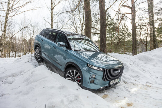Moscow. Russia - February 24: blue Chinese SUV Chery Jaecoo J7 in forest