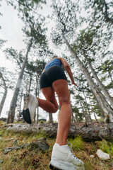 Adventurous Woman Overcoming Forest Obstacles with Determination and Agility.