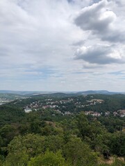 Obraz premium clouds over the mountains and small town in forest