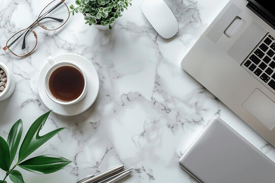 A clean white marble desk is shown with coffee, glasses and an open laptop computer. The camera is positioned directly above the table surface looking down at it from straight on.
