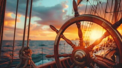 Fototapeta premium Deck view with ship wheel from a sailing ship with beautiful seascape at sunset.