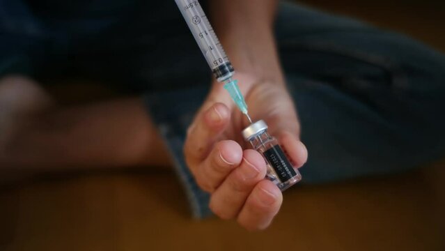 Woman injecting progesterone into her belly for fertility treatment, focusing on assisted reproduction, gynecology, and reproduction