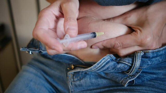 A woman injecting hormones into her stomach at home, illustrating hormone therapy and in vitro fertilization (IVF) treatment