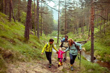 Young family hiking in the forest