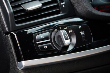 Light control panel in a modern passenger car. Car light switch. Dashboard for switching on the...