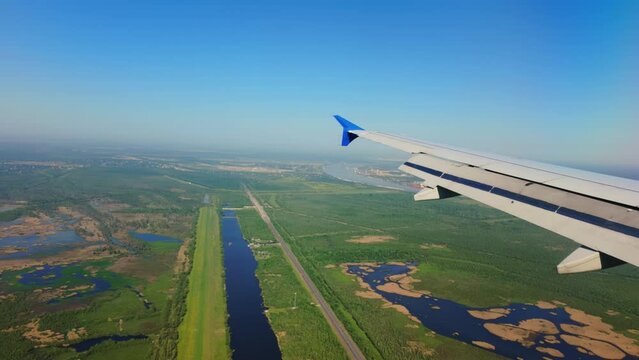 Louis Armstrong New Orleans International Airport MSY wide view from the porthole of the preparing to landing airplane. Wide shot