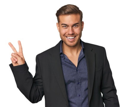 Businessman in suit, studio shot joyful and carefree showing a peace symbol with fingers.