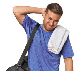 Athlete with gym bag, studio touching back of head, thinking and making a choice.