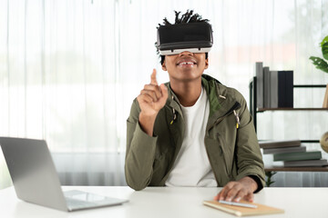 Young African American looking through VR pointing zoom for data online meeting hologram metaverse world connecting digital futuristic technology virtual reality at meta modern office. Contrivance.