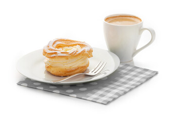 A cream puff on a white plate, a cup of coffee and a napkin. Isolate on a white background