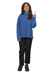 Middle Eastern woman, full body studio joyful and carefree showing a peace symbol with fingers.