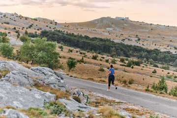 Obraz premium Empowered Runner Embracing Nature's Beauty on a Serene Morning Trail.