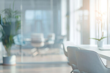A large window in a room with a potted plant and two chairs