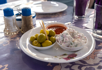 Moroccan moroccan dips, mezze with green olives, yogurt salad, harissa sauce served with toothpicks