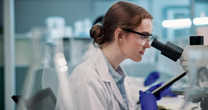 Scientist, woman and microscope or tablet in laboratory for results on medical research or experiment. Digital tech, professional or student with analysis on science development, study review or info