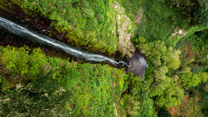 Waterfall in mountain terrain covered in algae