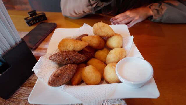 Plate of Brazilian Fried Snacks. Delicious Assortment of Traditional Brazilian Fried Appetizers with Dipping Sauce