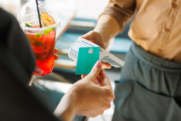 NFC credit card payment. Woman paying with contactless credit card with NFC