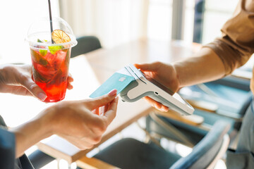 NFC credit card payment. Woman paying with contactless credit card with NFC