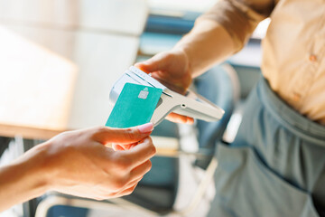 NFC credit card payment. Woman paying with contactless credit card with NFC