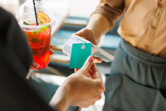 NFC credit card payment. Woman paying with contactless credit card with NFC