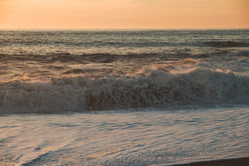 Sunset in the ocean by the lighthouse