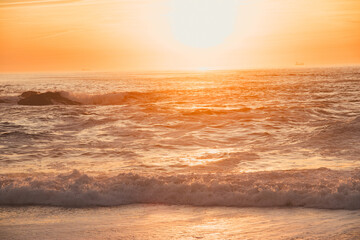 Sunset in the ocean by the lighthouse