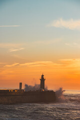 Sunset in the ocean by the lighthouse