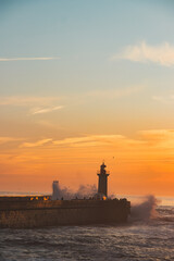 Sunset in the ocean by the lighthouse