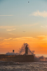 Sunset in the ocean by the lighthouse