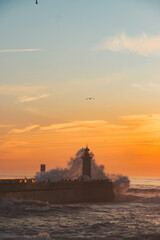 Sunset in the ocean by the lighthouse