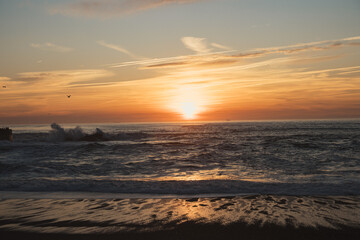 Sunset in the ocean by the lighthouse