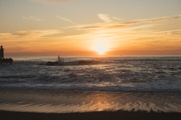 Sunset in the ocean by the lighthouse