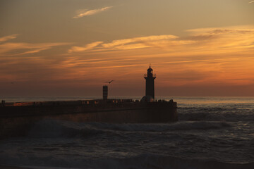 Sunset in the ocean by the lighthouse
