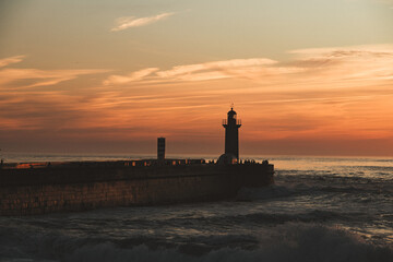 Sunset in the ocean by the lighthouse