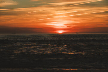 Sunset in the ocean by the lighthouse