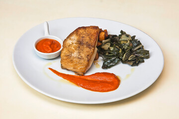 Fish fillet with spinach, potatoes and pepper sauce, school fish or black tuna, food