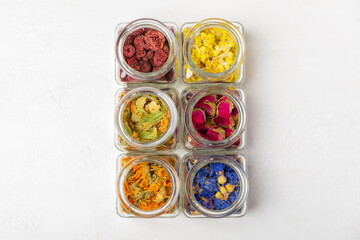 Assortment of dry herbal and berry tea on a wooden background. Tea party concept. medicinal herbs. Healing herbs.Alternative medicine.Linden, calendula, cornflowers, marigold, tansy, tea rose.