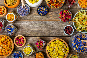 Assortment of dry herbal and berry tea on a wooden background. Tea party concept. medicinal herbs. Healing herbs.Alternative medicine.Linden, calendula, cornflowers, marigold, tansy, tea rose.