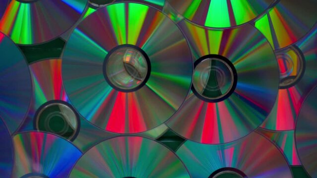 A collection of CDs with a rainbow effect