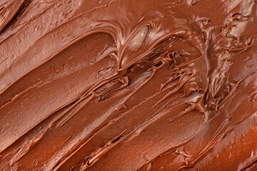 Melted chocolate cream as background, top view. Hazelnut cream, chocolate smear.