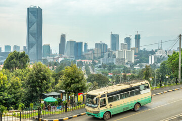 Сentral business district with modern downtown skyscrapers and passenger bus on the road, Addis...