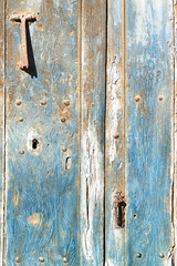metallic knocker on old  wooden door , vintage background