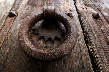 metallic knocker on old  wooden door , vintage background
