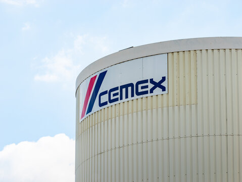 DRESDEN, GERMANY - 10. May 2024: Cemex logo sign on an industrial building like a silo. The company provides materials like cement for concrete at the construction industry.