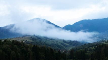 Mountain landscape with clouds and fog